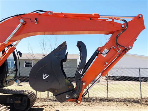 mini excavator bucket and thumb|excavator bucket with hydraulic thumb.